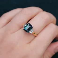 18ct Yellow and White Gold Teal/Parti Sapphire and Tapered Baguette Diamond 3 Stone Ring